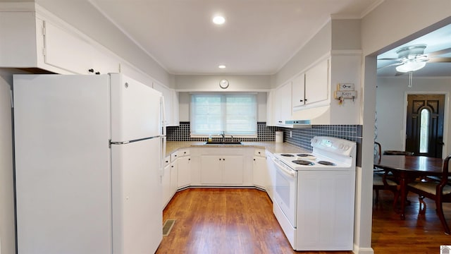 608 E 12th St, Benton, KY 42025 - kitchen with crown molding, a sink, wood finished floors, and white appliances