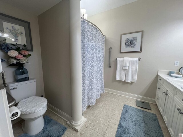 full bath featuring a shower with curtain, tile patterned flooring, baseboards, vanity, and toilet