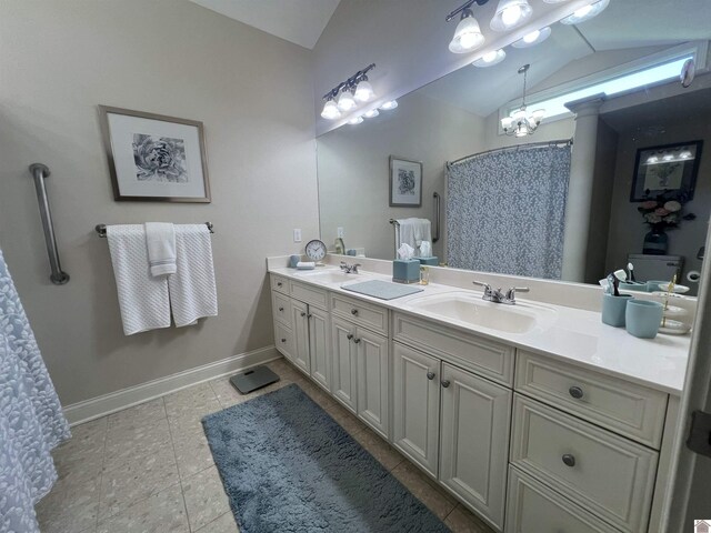full bath featuring a sink, tile patterned floors, double vanity, and lofted ceiling