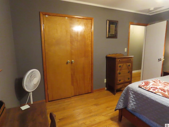 bedroom with baseboards and light wood finished floors