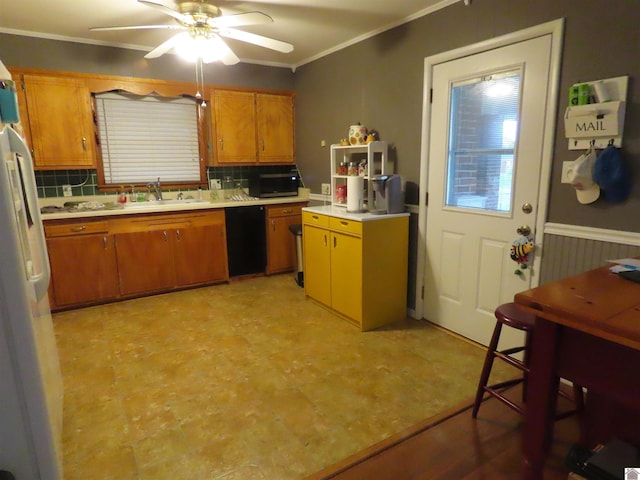 kitchen with a sink, light countertops, brown cabinetry, a ceiling fan, and decorative backsplash