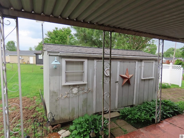 view of shed featuring fence