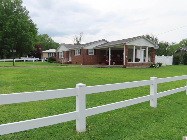 single story home featuring brick siding, a front lawn, and a fenced front yard