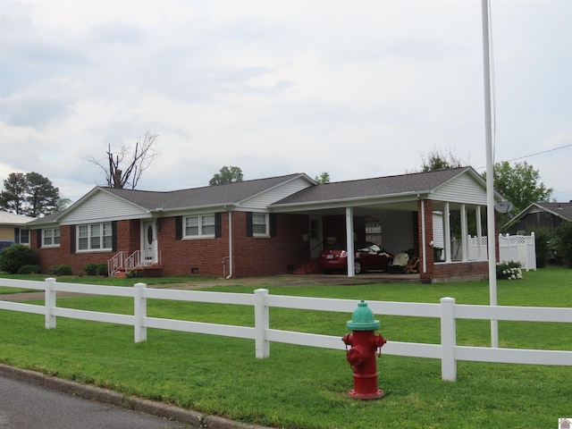 ranch-style house featuring brick siding, fence, a front yard, and an attached carport