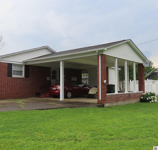 view of home's exterior featuring a yard, brick siding, driveway, and a carport
