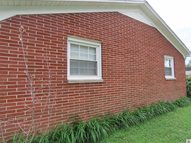 view of side of home featuring brick siding