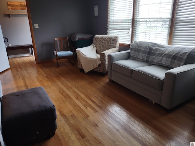 living room featuring baseboards and light wood-style flooring