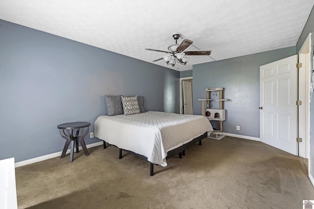 carpeted bedroom featuring baseboards, ceiling fan, and a textured ceiling
