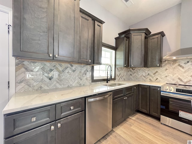 1360 Eagle Ln, Mayfield, KY 42066 - kitchen with light wood-type flooring, wall chimney exhaust hood, light stone counters, a sink, and stainless steel appliances