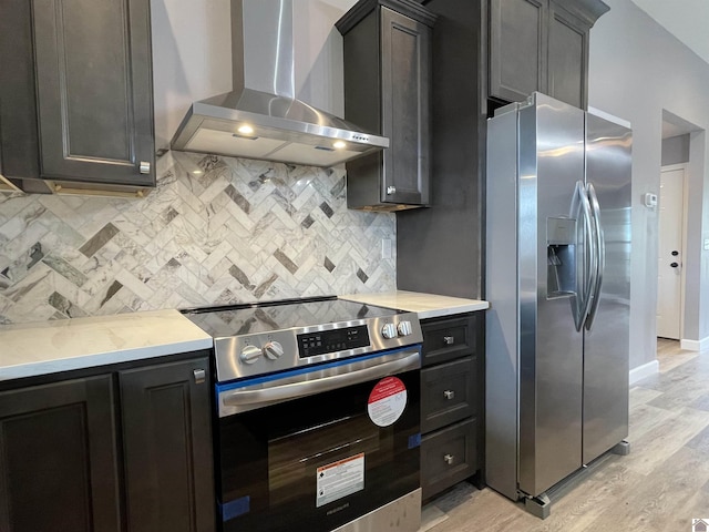 1360 Eagle Ln, Mayfield, KY 42066 - kitchen featuring stainless steel appliances, decorative backsplash, wall chimney exhaust hood, and light wood-style floors