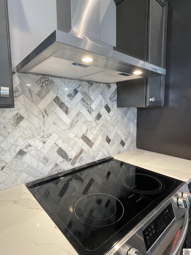 1360 Eagle Ln, Mayfield, KY 42066 - kitchen with wall chimney range hood, range with electric stovetop, backsplash, light stone countertops, and marble finish floor