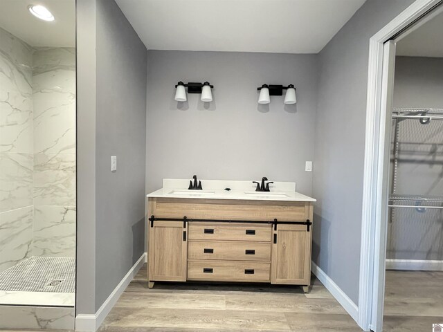 1360 Eagle Ln, Mayfield, KY 42066 - full bath featuring double vanity, walk in shower, a sink, and wood finished floors
