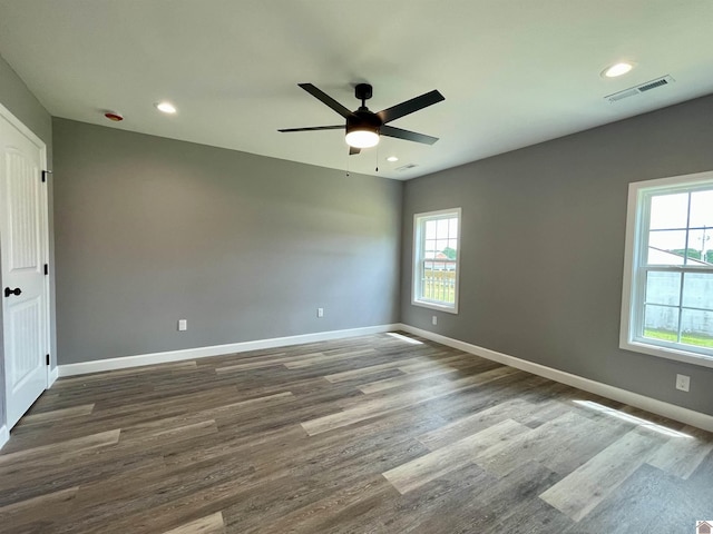 1360 Eagle Ln, Mayfield, KY 42066 - unfurnished room with plenty of natural light, a ceiling fan, dark wood-type flooring, and visible vents