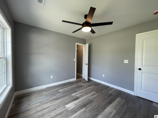 1360 Eagle Ln, Mayfield, KY 42066 - unfurnished bedroom with baseboards, ceiling fan, dark wood finished floors, and visible vents
