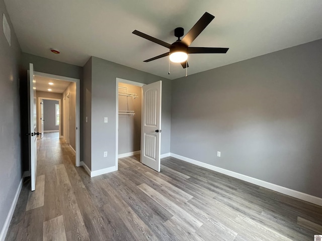1360 Eagle Ln, Mayfield, KY 42066 - unfurnished bedroom with a closet, baseboards, a ceiling fan, and wood finished floors