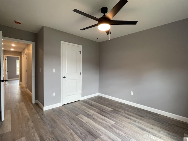 1360 Eagle Ln, Mayfield, KY 42066 - unfurnished bedroom with baseboards, a ceiling fan, and wood finished floors