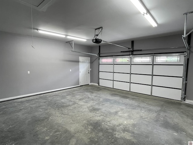1360 Eagle Ln, Mayfield, KY 42066 - garage featuring baseboards and a garage door opener