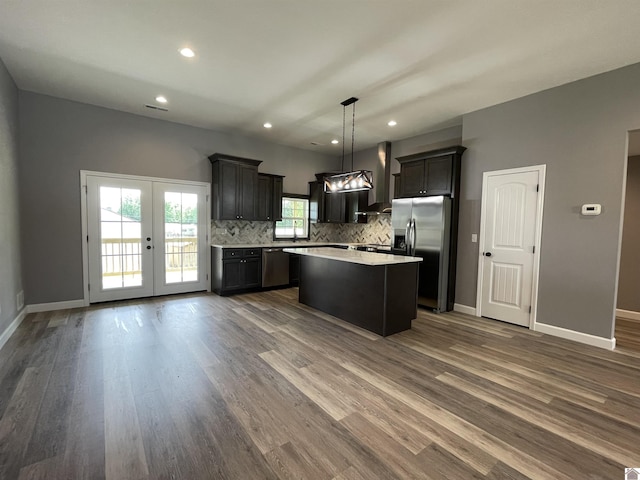 1360 Eagle Ln, Mayfield, KY 42066 - kitchen featuring a kitchen island, dark wood-style floors, light countertops, backsplash, and stainless steel appliances