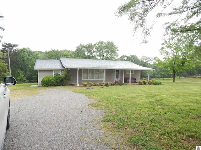 2286 Murray Hwy, Benton, KY 42025 - view of front of house featuring a porch, a front lawn, and gravel driveway