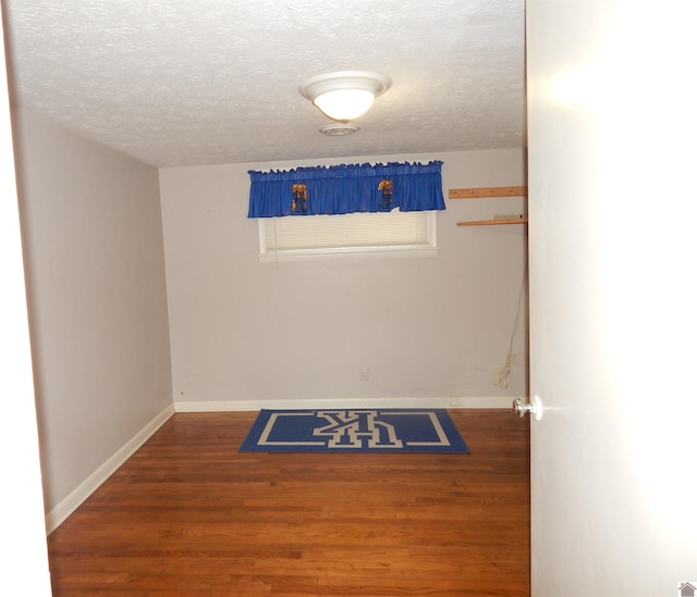 2286 Murray Hwy, Benton, KY 42025 - empty room with baseboards, a textured ceiling, and wood finished floors