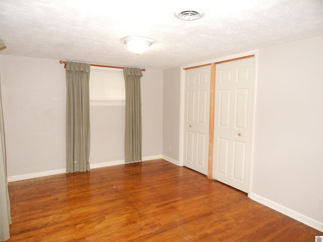 2286 Murray Hwy, Benton, KY 42025 - unfurnished bedroom with visible vents, baseboards, wood finished floors, and a closet