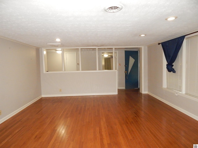 2286 Murray Hwy, Benton, KY 42025 - unfurnished living room with a textured ceiling, baseboards, wood finished floors, and visible vents
