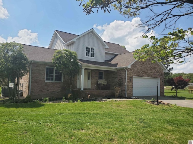 traditional-style house with a porch, brick siding, concrete driveway, and a front lawn