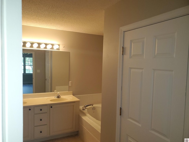 full bathroom featuring a bath, double vanity, and a textured ceiling