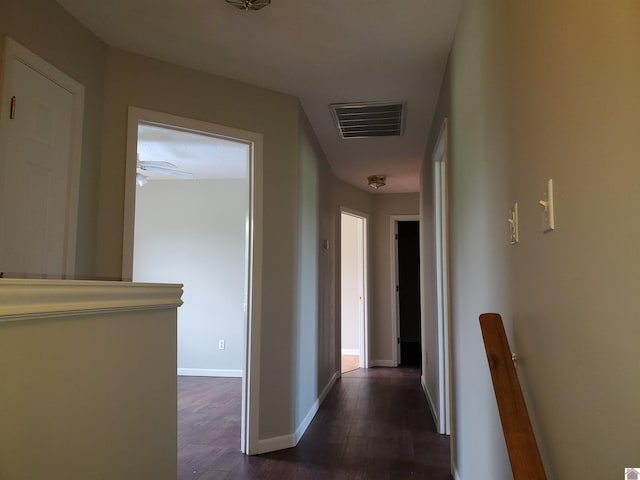 hall with dark wood finished floors and baseboards