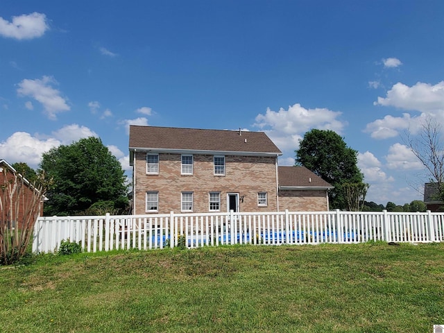 view of front of home with brick siding and a pool