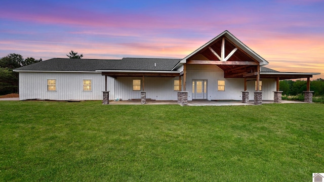 rear view of property with a patio and a yard