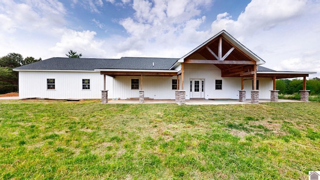 back of property featuring a patio and a yard