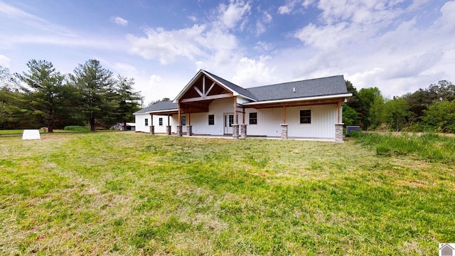 back of house featuring a lawn and a patio
