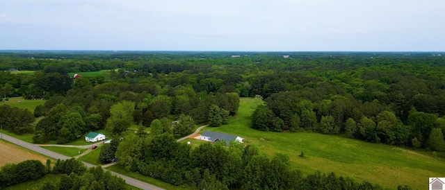 birds eye view of property featuring a view of trees