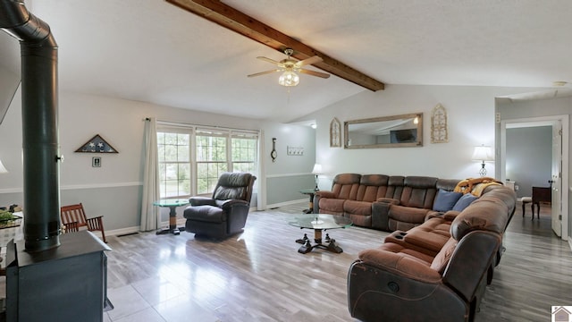 486 Mermie, Hardin, KY 42048 - living room featuring a wood stove, a ceiling fan, baseboards, vaulted ceiling with beams, and wood finished floors