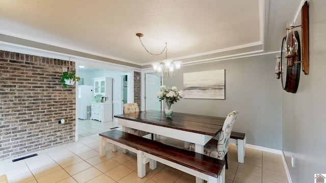 486 Mermie, Hardin, KY 42048 - dining room featuring an inviting chandelier, light tile patterned flooring, brick wall, and visible vents