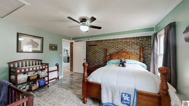 486 Mermie, Hardin, KY 42048 - bedroom featuring baseboards, ceiling fan, wood finished floors, and brick wall