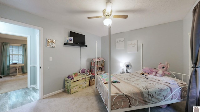 486 Mermie, Hardin, KY 42048 - carpeted bedroom with baseboards, ceiling fan, a textured ceiling, and wood finished floors