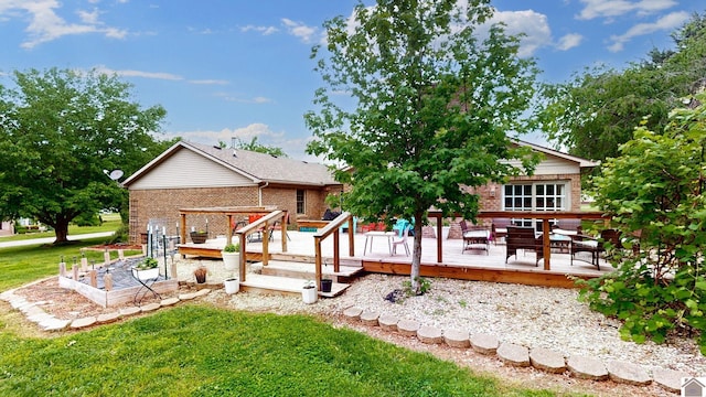 486 Mermie, Hardin, KY 42048 - back of property with brick siding, a wooden deck, and a yard
