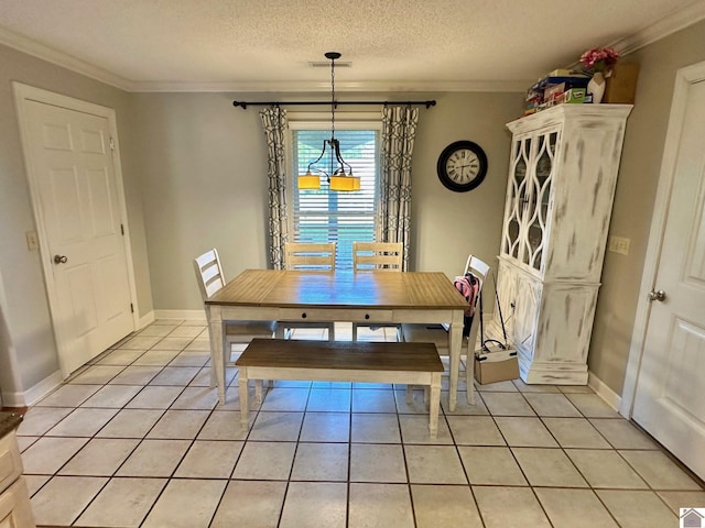 dining space featuring crown molding, baseboards, light tile patterned floors, and visible vents