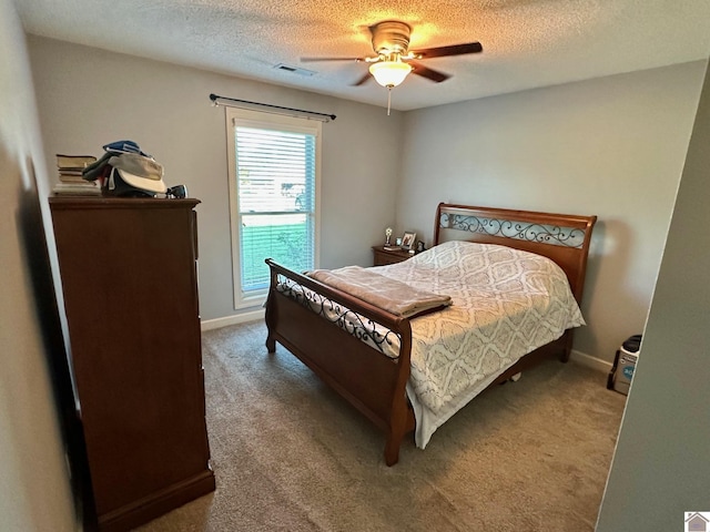 bedroom featuring a textured ceiling, carpet floors, and visible vents