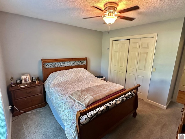 carpeted bedroom featuring a textured ceiling, a closet, and a ceiling fan