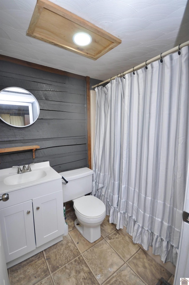 198 Mandor Rd, Hardin, KY 42048 - bathroom featuring tile patterned floors, toilet, wooden walls, and vanity