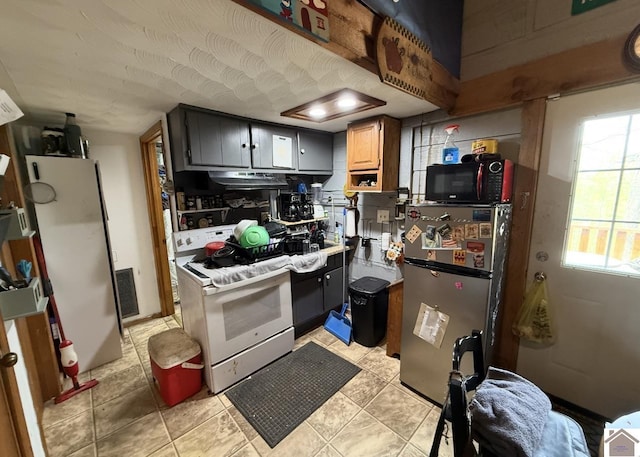 198 Mandor Rd, Hardin, KY 42048 - kitchen with under cabinet range hood, visible vents, a healthy amount of sunlight, and white appliances
