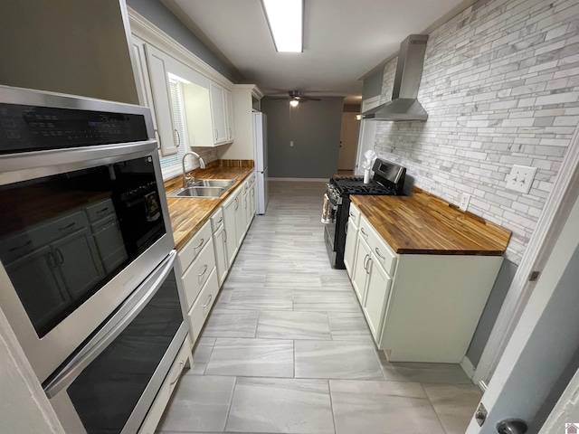 429 S 2nd St, Mayfield, KY 42066 - kitchen with a sink, stainless steel appliances, wall chimney range hood, tasteful backsplash, and butcher block counters