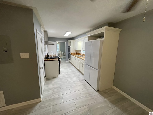 429 S 2nd St, Mayfield, KY 42066 - kitchen with baseboards, a sink, white cabinetry, open shelves, and stainless steel appliances