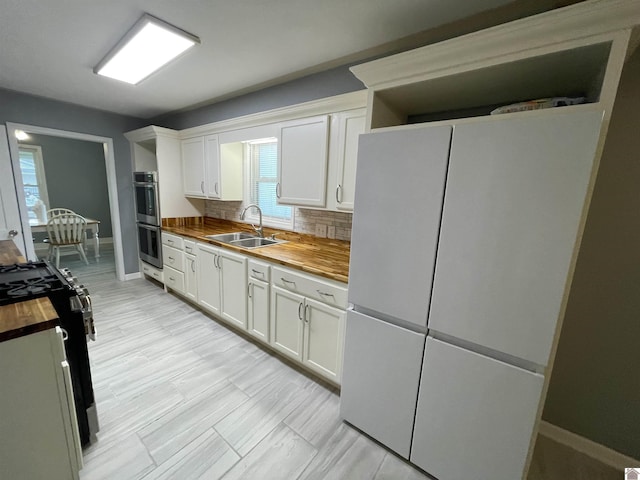 429 S 2nd St, Mayfield, KY 42066 - kitchen featuring freestanding refrigerator, butcher block counters, a sink, double oven, and tasteful backsplash