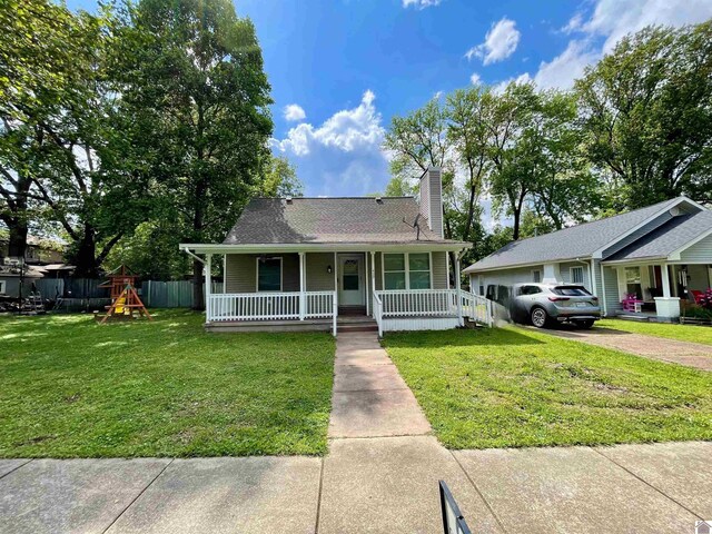 429 S 2nd St, Mayfield, KY 42066 - bungalow-style house featuring covered porch, fence, a front yard, a chimney, and a playground