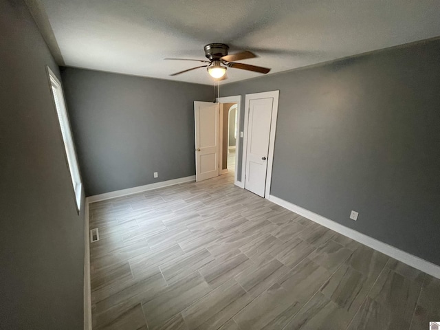 429 S 2nd St, Mayfield, KY 42066 - unfurnished bedroom with light wood finished floors, baseboards, and a ceiling fan