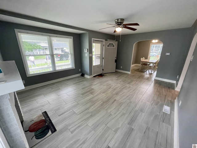 429 S 2nd St, Mayfield, KY 42066 - interior space with light wood finished floors, baseboards, a ceiling fan, and arched walkways